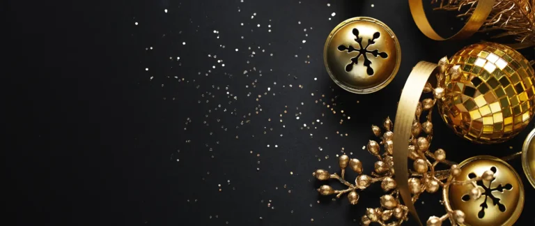 Holiday-themed gold decorations on a black background for AGAT Laboratories holiday hours announcement