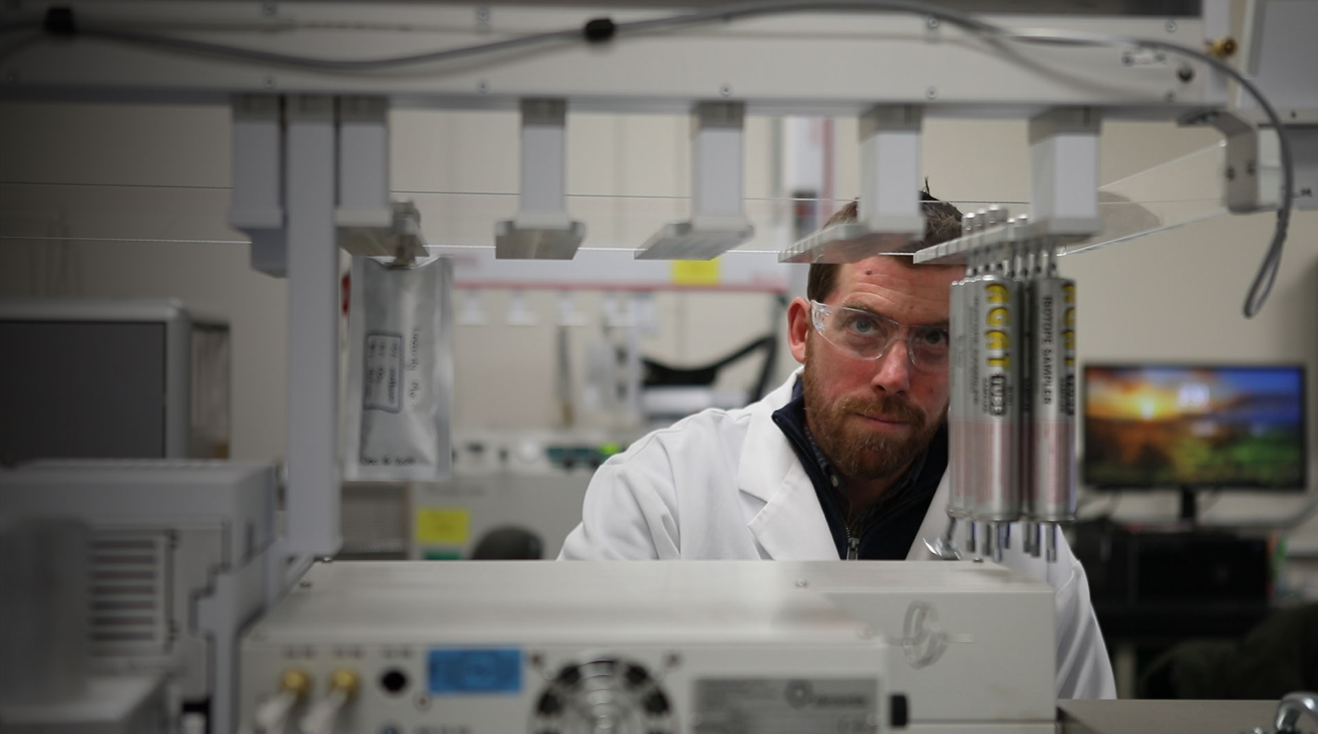Scientifique d'AGAT Laboratories opérant un équipement de pointe pour l'analyse géochimique moléculaire et isotopique.